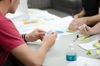 Person At A Table With A Notepad