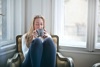 Woman Sitting In A Comfy Chair Holding Gray Ceramic Mug