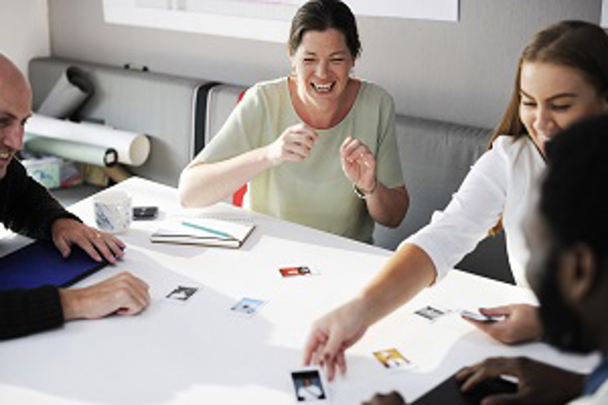 Four People Playing A Card Game