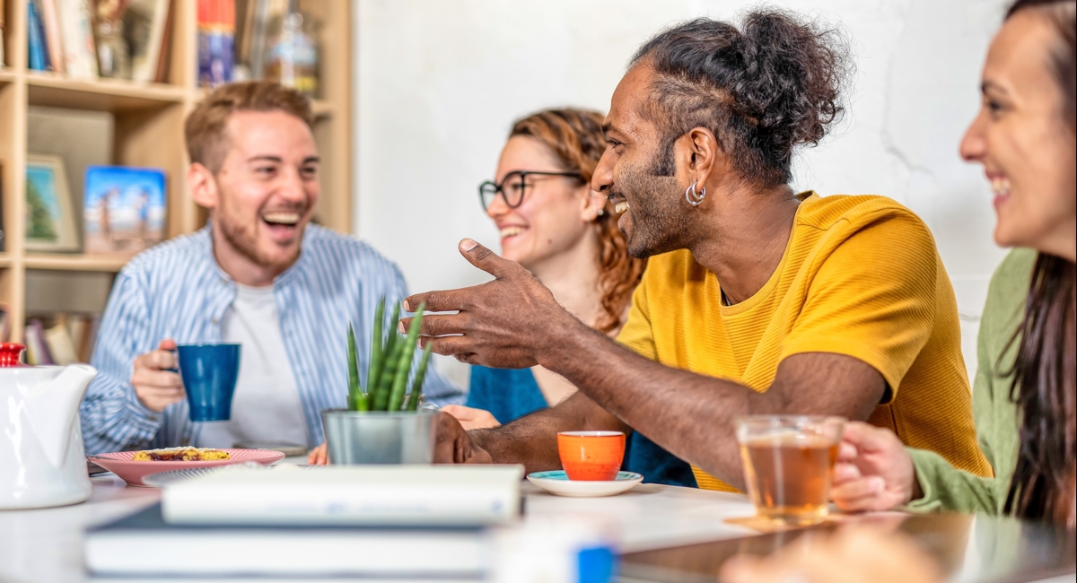 Happy Colleagues Sitting Down In Conversation