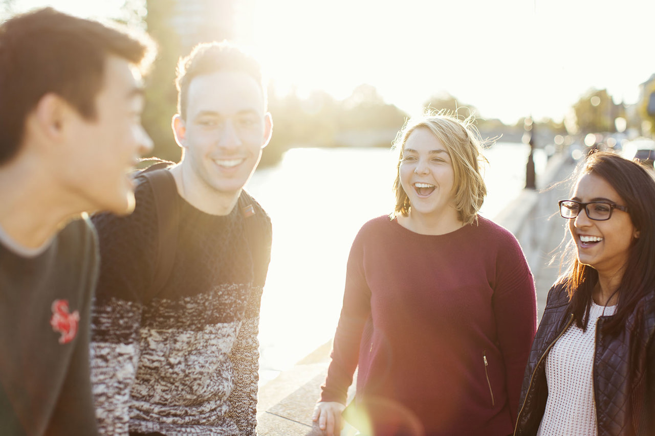 Four People Standing Smiling