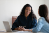 A Woman With A Laptop Talking To Colleague