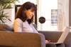 A woman on a laptop sitting down