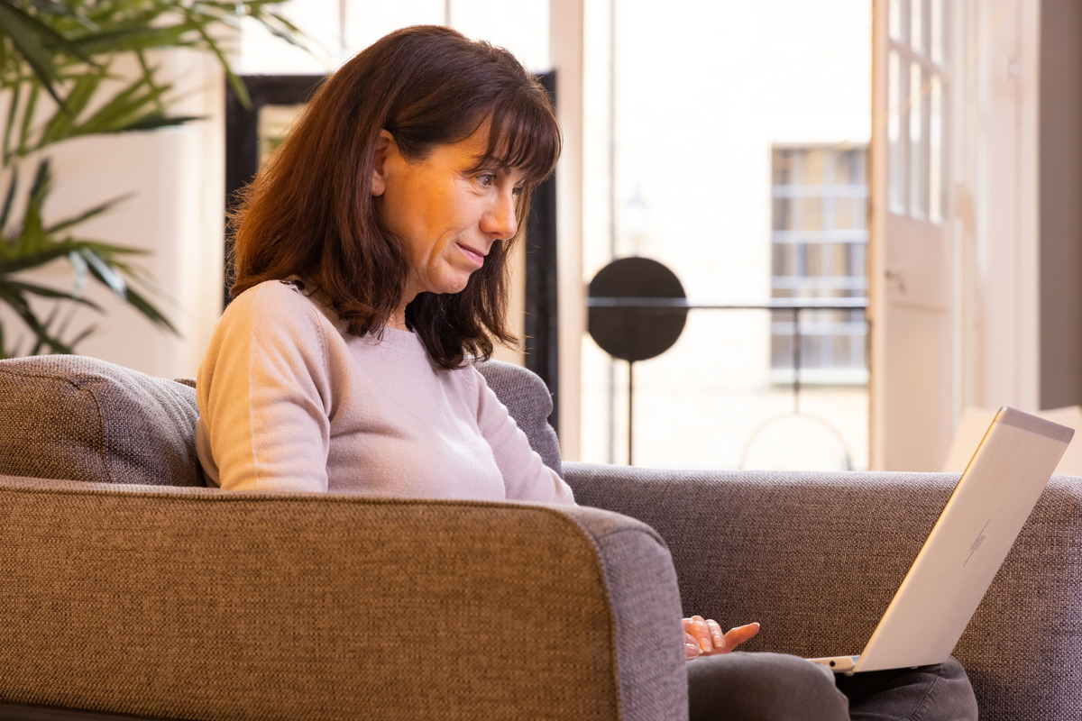 A woman on a laptop sitting down