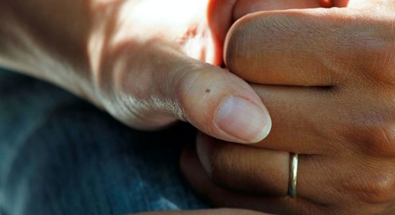 A hand holding another hand