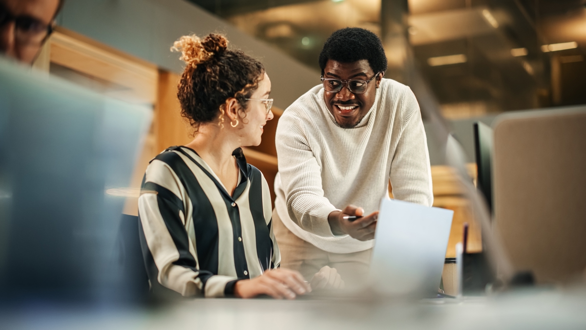 Two Creative Young Colleagues Consulting Each Other