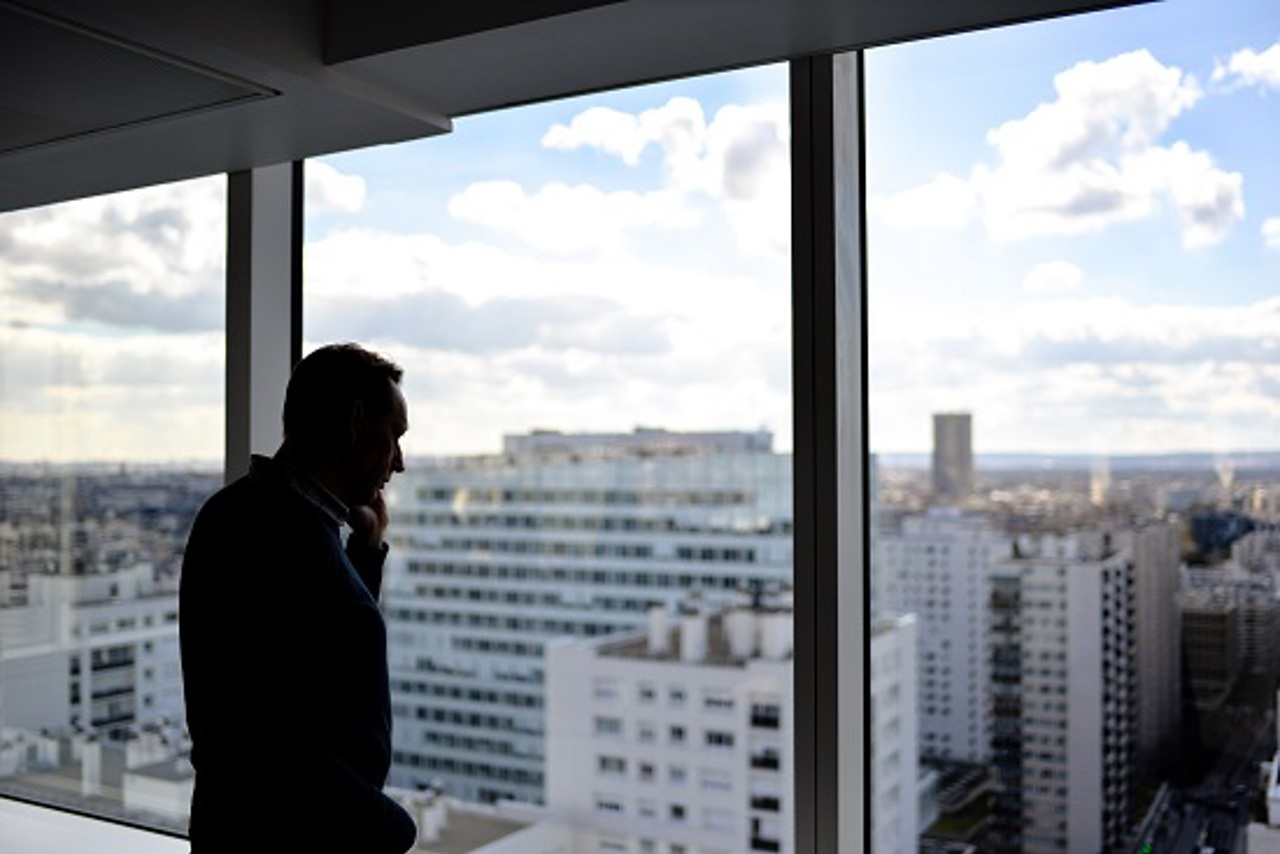A Man Looking Out A Window