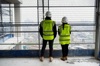 Two People In Construction Clothes On Site
